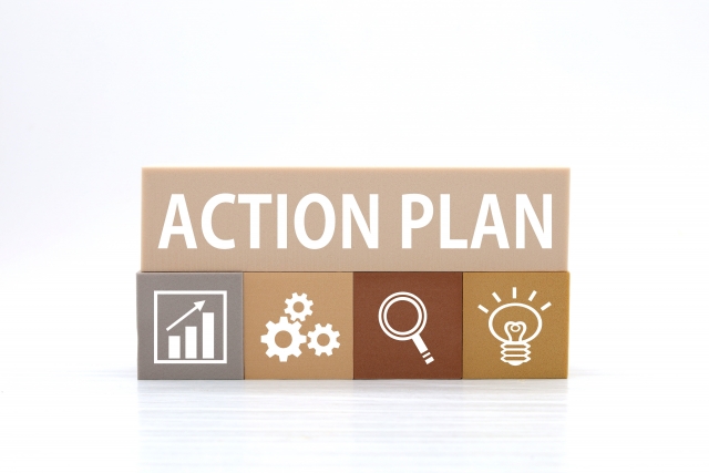 木のブロックで「ACTION PLAN」と書かれたイラスト