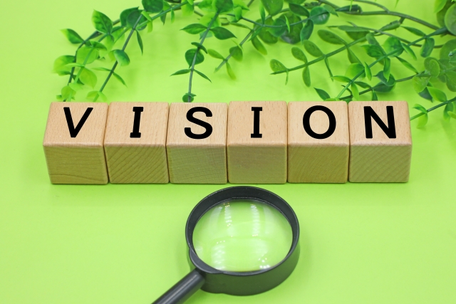 ブロックに「VISION」と書かれた文字と虫眼鏡のイラスト